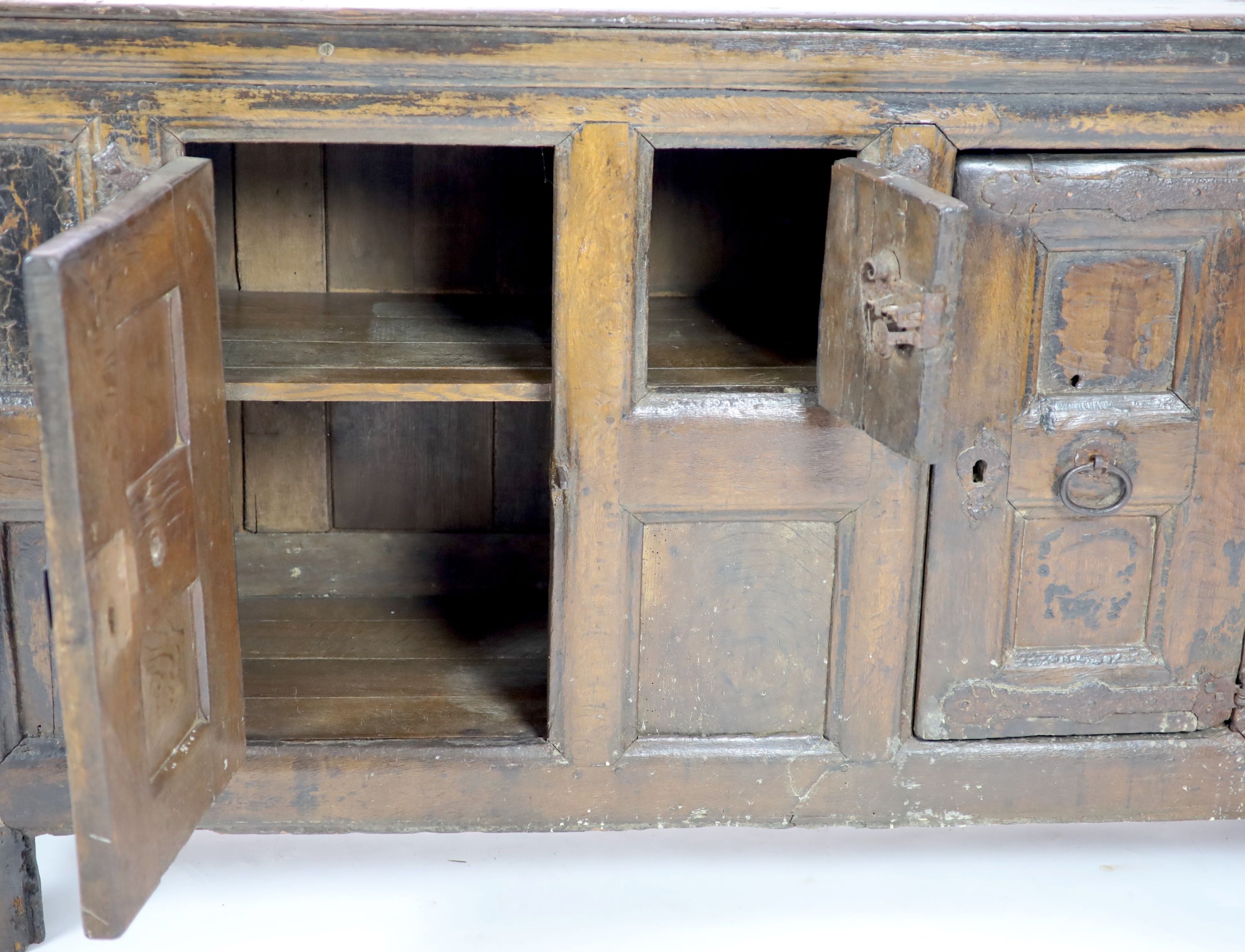 A late 16th/early 17th century German oak side cupboard H 104cm. W 185cm. D 49cm.